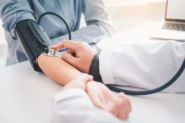 Photo of doctor checking a blood pressure.